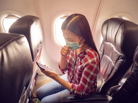 Asian tourist feeling sick, coughing ,wearing mask to prevent during travel time by airplane for protect from the new Coronavirus 2019 infection outbreak situation
