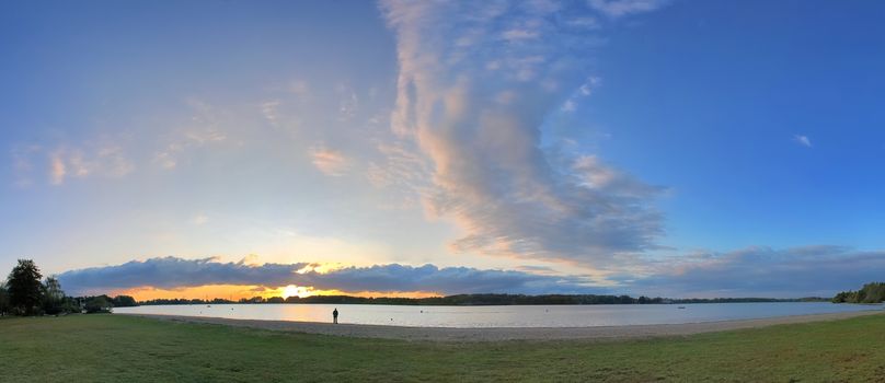 Beautiful high resolution panorama of a northern european country landscape with fields and green grass.