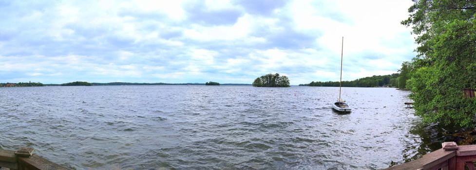 Beautiful high resolution panorama of a northern european country landscape with fields and green grass.