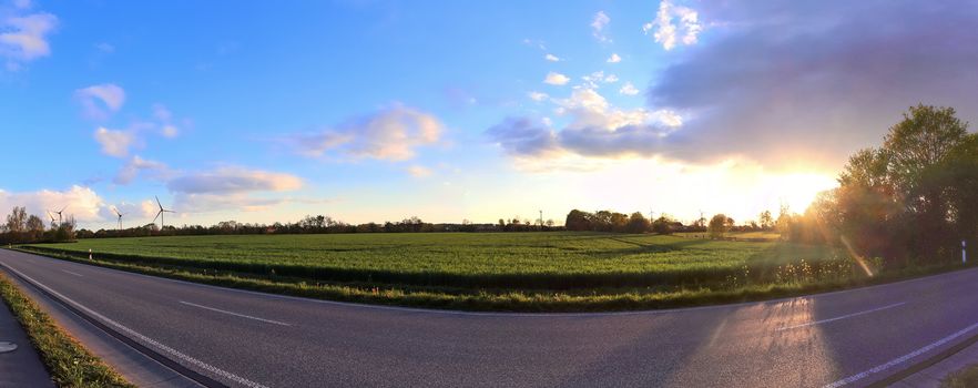 Beautiful high resolution panorama of a northern european country landscape with fields and green grass.