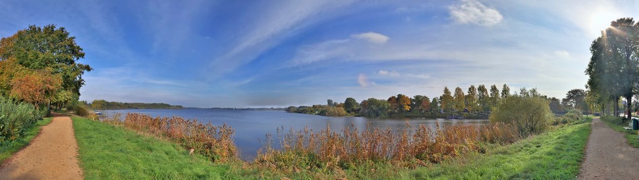 Beautiful high resolution panorama of a northern european country landscape with fields and green grass.