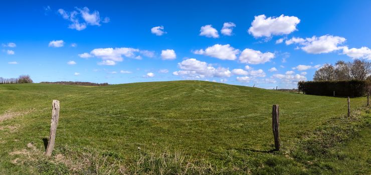 Beautiful high resolution panorama of a northern european country landscape with fields and green grass.