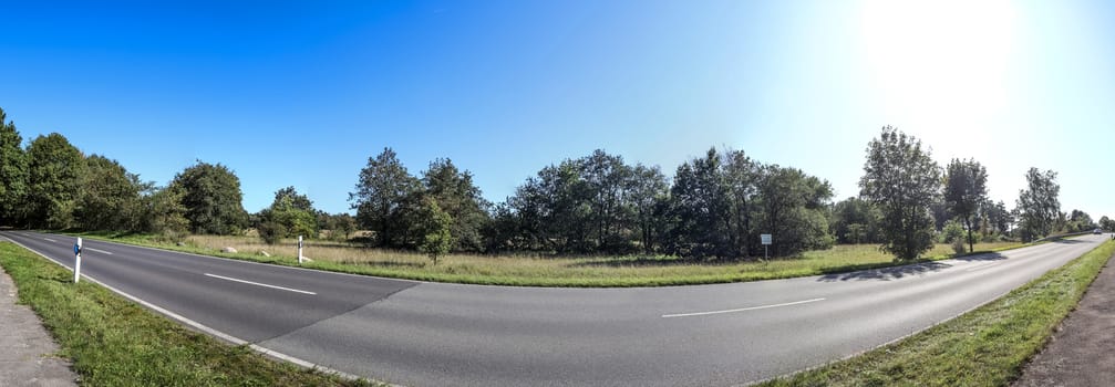 Beautiful high resolution panorama of a northern european country landscape with fields and green grass.