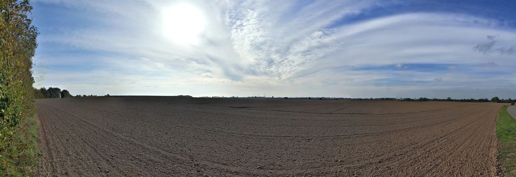 Beautiful high resolution panorama of a northern european country landscape with fields and green grass.