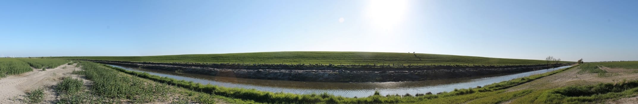 Beautiful high resolution panorama of a northern european country landscape with fields and green grass.