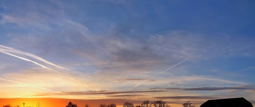 Beautiful high resolution panorama of a northern european country landscape with fields and green grass.