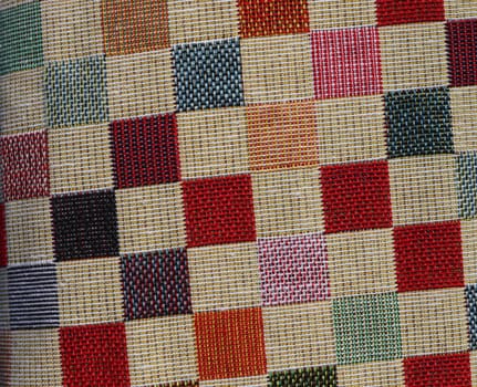 Detailed close up view on samples of cloth and fabrics in different colors found at a fabrics market.