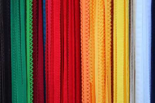 Detailed close up view on samples of cloth and fabrics in different colors found at a fabrics market.