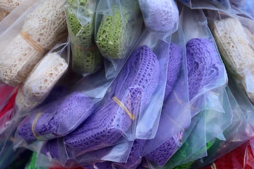 Detailed close up view on samples of cloth and fabrics in different colors found at a fabrics market.