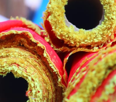 Detailed close up view on samples of cloth and fabrics in different colors found at a fabrics market.