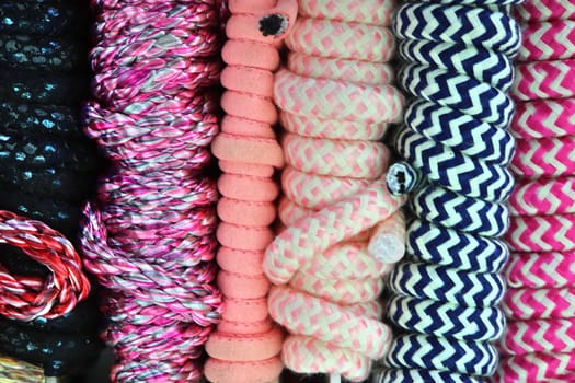 Detailed close up view on samples of cloth and fabrics in different colors found at a fabrics market.