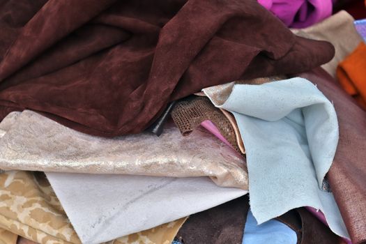 Detailed close up view on samples of cloth and fabrics in different colors found at a fabrics market.