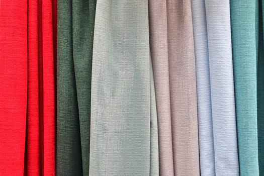 Detailed close up view on samples of cloth and fabrics in different colors found at a fabrics market.