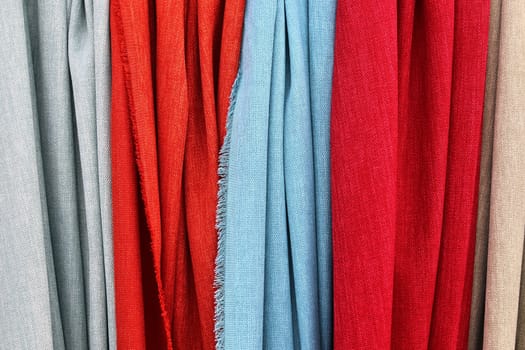 Detailed close up view on samples of cloth and fabrics in different colors found at a fabrics market.