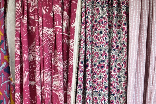 Detailed close up view on samples of cloth and fabrics in different colors found at a fabrics market.