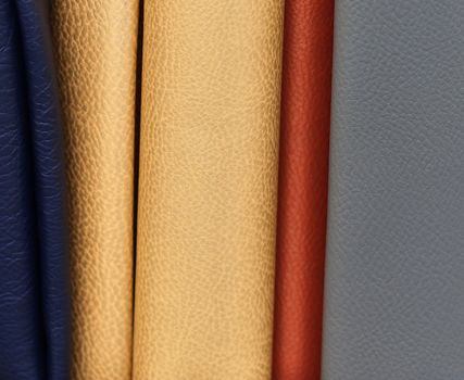 Detailed close up view on samples of cloth and fabrics in different colors found at a fabrics market.