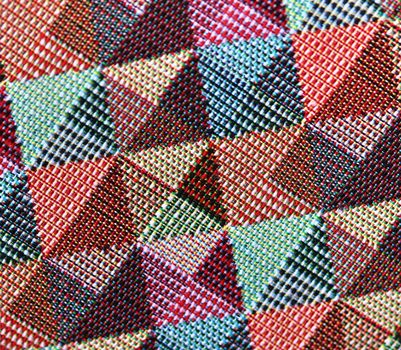 Detailed close up view on samples of cloth and fabrics in different colors found at a fabrics market.