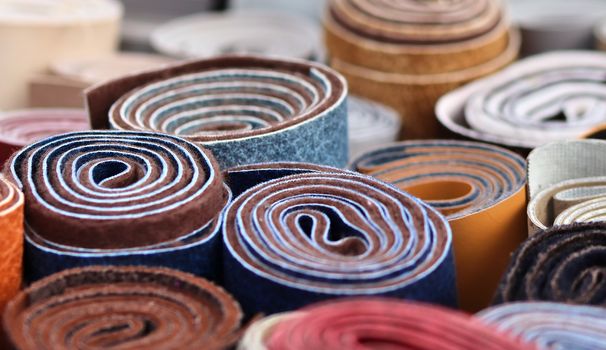 Detailed close up view on samples of cloth and fabrics in different colors found at a fabrics market.