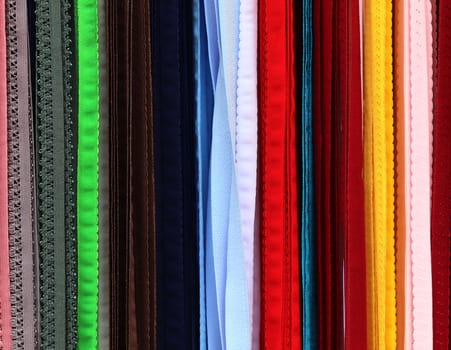 Detailed close up view on samples of cloth and fabrics in different colors found at a fabrics market.