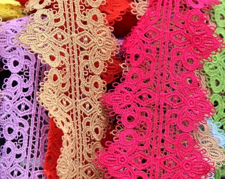 Detailed close up view on samples of cloth and fabrics in different colors found at a fabrics market.