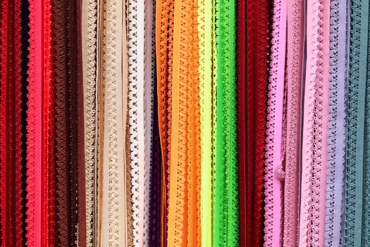 Detailed close up view on samples of cloth and fabrics in different colors found at a fabrics market.