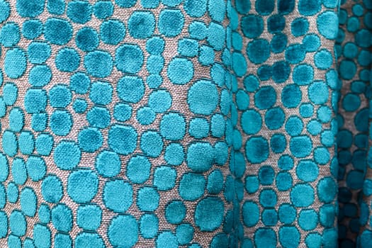 Detailed close up view on samples of cloth and fabrics in different colors found at a fabrics market.