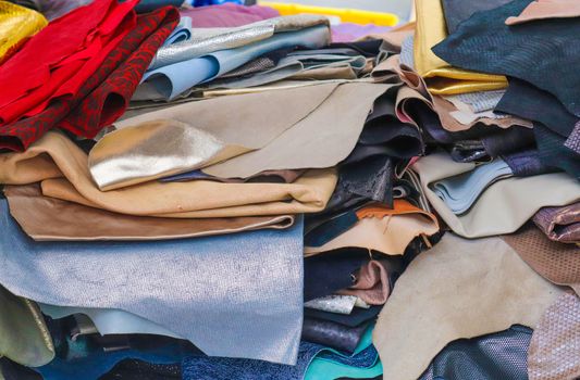 Detailed close up view on samples of cloth and fabrics in different colors found at a fabrics market.