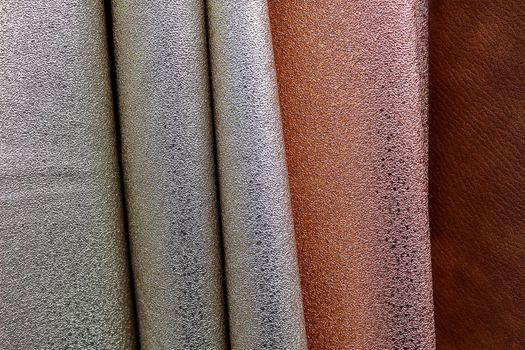 Detailed close up view on samples of cloth and fabrics in different colors found at a fabrics market.