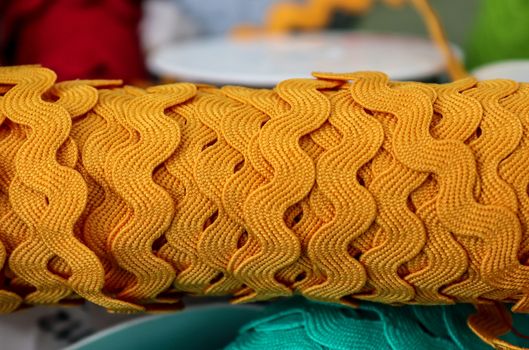 Detailed close up view on samples of cloth and fabrics in different colors found at a fabrics market.