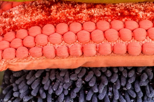 Detailed close up view on samples of cloth and fabrics in different colors found at a fabrics market.