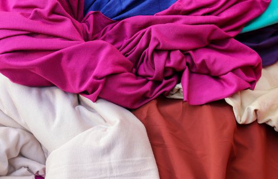 Detailed close up view on samples of cloth and fabrics in different colors found at a fabrics market.