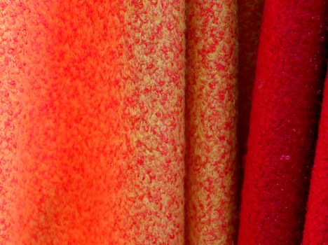 Detailed close up view on samples of cloth and fabrics in different colors found at a fabrics market.