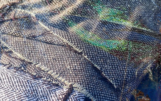 Detailed close up view on samples of cloth and fabrics in different colors found at a fabrics market.