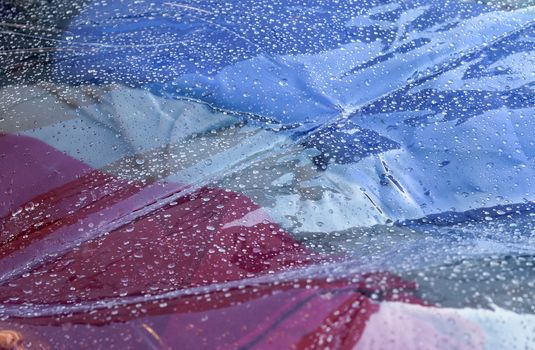 Detailed close up view on samples of cloth and fabrics in different colors found at a fabrics market.