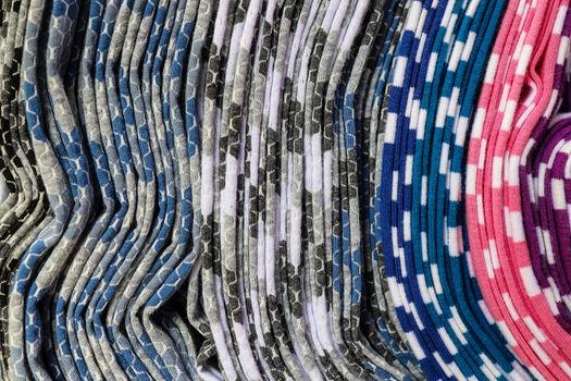 Detailed close up view on samples of cloth and fabrics in different colors found at a fabrics market.