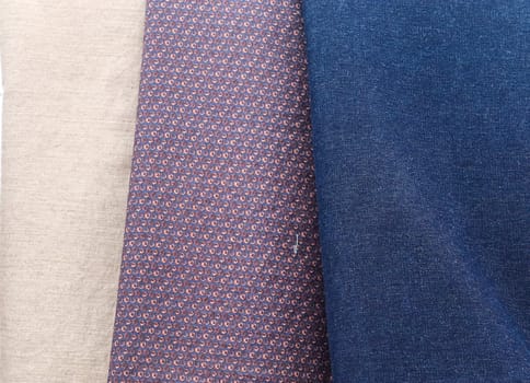 Detailed close up view on samples of cloth and fabrics in different colors found at a fabrics market.