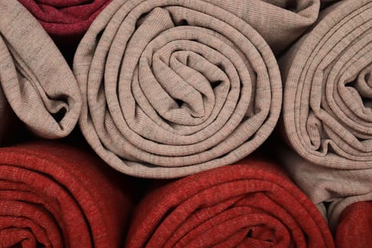 Detailed close up view on samples of cloth and fabrics in different colors found at a fabrics market.