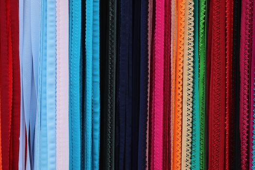 Detailed close up view on samples of cloth and fabrics in different colors found at a fabrics market.