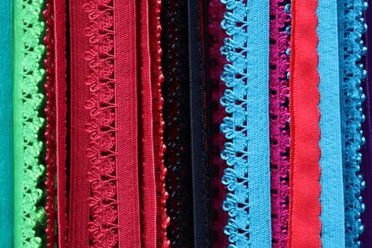 Detailed close up view on samples of cloth and fabrics in different colors found at a fabrics market.