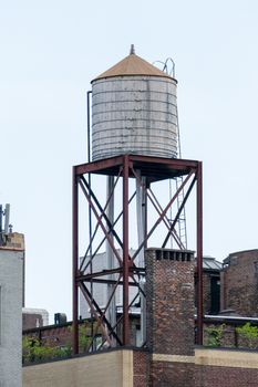 a typical water tank on the roof of a building in New York City