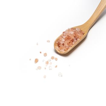 Himalayan pink salt with wooden spoon on table