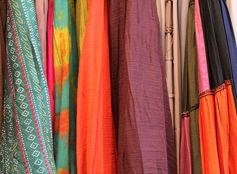 Detailed close up view on samples of cloth and fabrics in different colors found at a fabrics market.