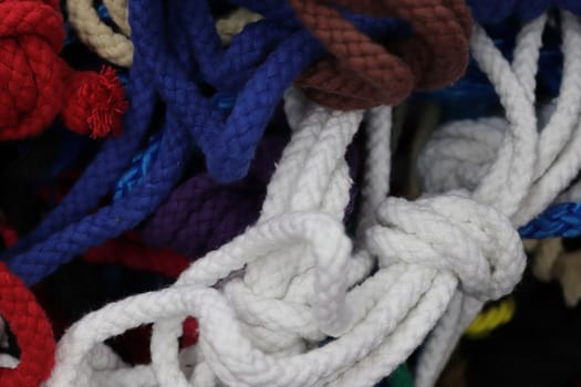 Detailed close up view on samples of cloth and fabrics in different colors found at a fabrics market.