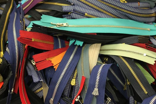 Detailed close up view on samples of cloth and fabrics in different colors found at a fabrics market.