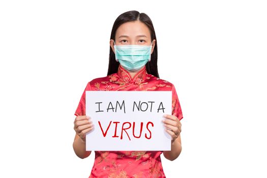 Asian woman in Chinese costume wear a hygienic mask holding sign I am not a VIRUS for anti racism , bullying and hate in the outbreak situation of Coronavirus 2019 infection or Covid-19