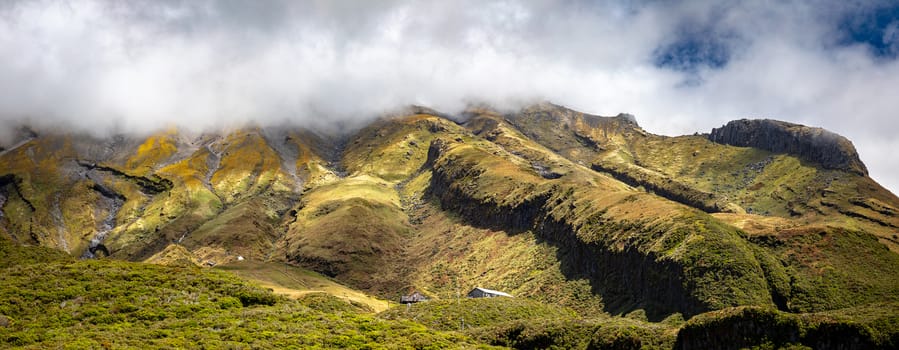 An image of the volcano Taranaki covered in clouds, New Zealand