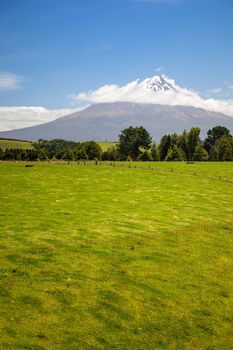 An image of the volcano Taranaki covered in clouds, New Zealand