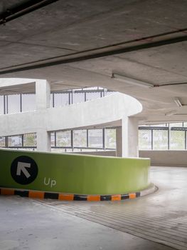 ramp of a parking structure. There is a yellow, black symbol. This image is the parking lot of the department store.