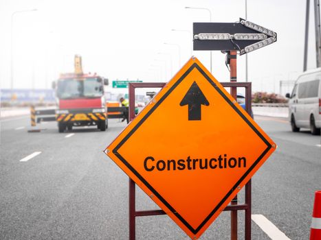 The signs repairs road and worker on the road