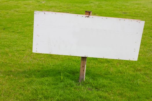 wood label sign in green grass